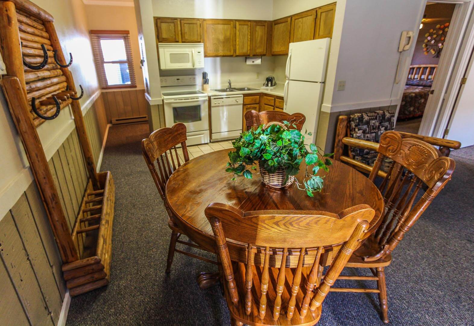 A dining room table and a full equipped kitchen at VRI's Jackson Hole Towncenter in Wyoming.